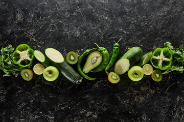 Wall Mural - top view of apples, avocado, cucumbers, kiwi, limes, peppers, greenery and zucchini