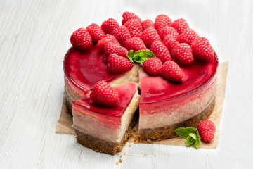 Wall Mural - Homemade cheesecake with raspberry jelly isolated on white