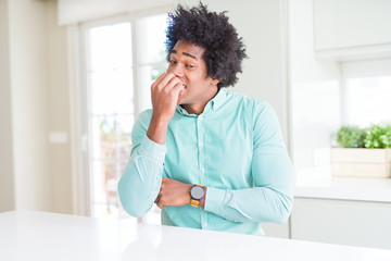 Poster - African American business man wearing elegant shirt looking stressed and nervous with hands on mouth biting nails. Anxiety problem.