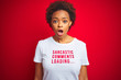 African american woman wearing sarcastic comments t-shirt over red isolated background afraid and shocked with surprise expression, fear and excited face.