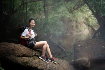 Wall Mural - Happy backpack woman in forest