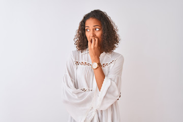 Poster - Young brazilian woman wearing shirt standing over isolated white background looking stressed and nervous with hands on mouth biting nails. Anxiety problem.