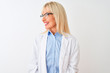 © Krakenimages.com - Middle age scientist woman wearing glasses standing over isolated white background looking away to side with smile on face, natural expression. Laughing confident.