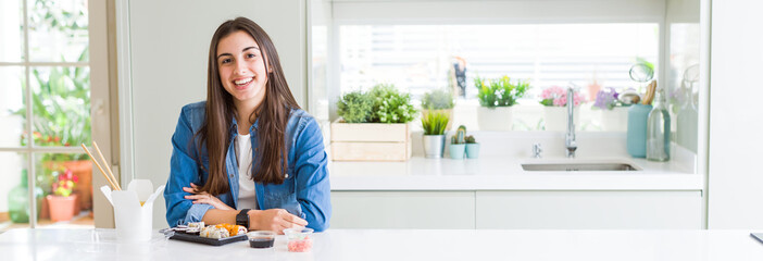 Canvas Print - Wide angle picture of beautiful young woman eating delivery sushi with a happy and cool smile on face. Lucky person.