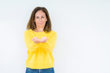 Wall Mural - Beautiful middle age woman wearing yellow sweater over isolated background Smiling with hands palms together receiving or giving gesture. Hold and protection