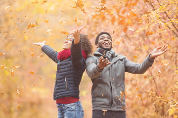 African-american couple spending fun time in autumn park