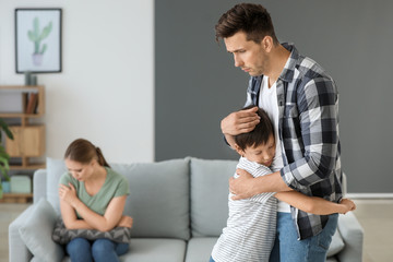 Wall Mural - Man calming his son after family quarrel at home