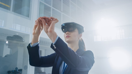 Aufkleber - Female Engineer Using Augmented Reality Headset Making Gestures of working with Virtual Objects in the Air. In Innovation High Tech Laboratory Facility with Futuristic Atmosphere.
