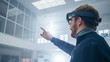 © Gorodenkoff - Automotive Engineer Using Augmented Reality Headset and Making Touching Gestures of Virtual Objects in the Air. In Innovation High Tech Laboratory Facility with Futuristic Atmosphere.