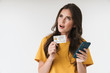 © Drobot Dean - Image of attractive brunette woman wearing casual clothes holding credit card and cellphone