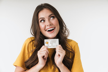 Sticker - Image of caucasian brunette woman wearing casual clothes smiling and holding credit card