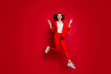 Full Body Photo Of Charming Woman Making V-signs Jumping Isolated Over Red Background