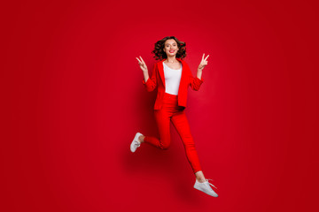 Wall Mural - full body photo of charming woman making v-signs jumping isolated over red background