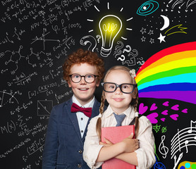 Brainstorm, idea and creativity concept. Happy smart kids in glasses on blackboard background with light bulb, science formulas and arts pattern