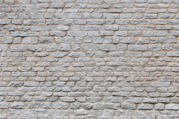 Wall Mural - Texture of a stone wall. Old castle stone wall texture background. Stone wall as a background or texture. Part of a stone wall, for background or texture.