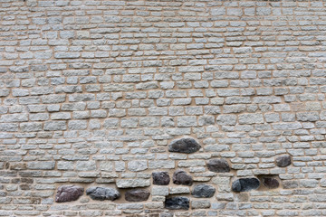 Wall Mural - Texture of a stone wall. Old castle stone wall texture background. Stone wall as a background or texture. Part of a stone wall, for background or texture.