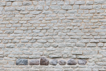 Wall Mural - Texture of a stone wall. Old castle stone wall texture background. Stone wall as a background or texture. Part of a stone wall, for background or texture.