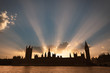 Dramatic sun beams behind the Palace of Westminster as the sun sets in London.