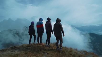 Wall Mural - the four people standing on a picturesque mountain