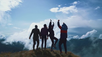 Wall Mural - the four happy people standing on a mountain
