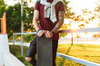 © Drobot Dean - Attractive cheerful young man sitting at the skate park ramp