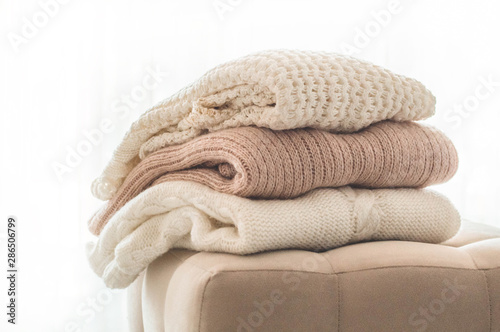 Fotomural A stack of knitted sweaters in the interior of the living room