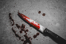 Bloody Knife Lies On The Creepy Messy Background With Dark Red Drops