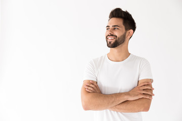 Image of attractive young man smiling and looking aside at copyspace