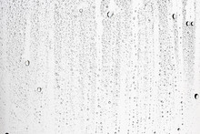 White Isolated Background Water Drops On The Glass / Wet Window Glass With Splashes And Drops Of Water And Lime, Texture Autumn Background