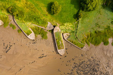 Aerial Drone View Of Silt Filled Abandoned Ships On The Banks On A Muddy River