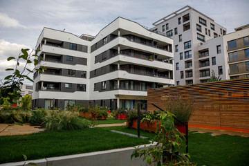 Patio between modern houses. Image of a cozy green city space.