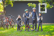 Children Mechanics, Bicycle Repair. Happy Kids Fixing Bike Together Outdoors In Sunny Day. Bicycle Repair Concept. Teamwork Family Posing With Tools For Repairing A Bicycle In Hands Outside
