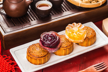 Poster - Traditional mooncakes on table setting with teacup.