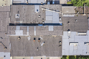 Wall Mural - drone aerial view of warehouse at industrial area with old weathered roof 