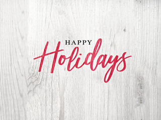 Wall Mural - happy holidays calligraphy red christmas text over white rustic wood background