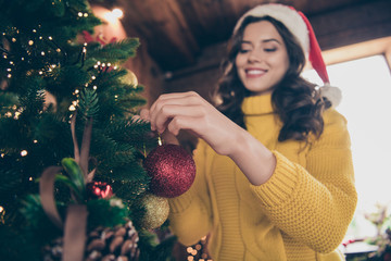 Wall Mural - Low below angle view photo of nice charming fascinating girlfriend wearing yellow jumper decorating her christmas fur tree while wearing yellow jumper