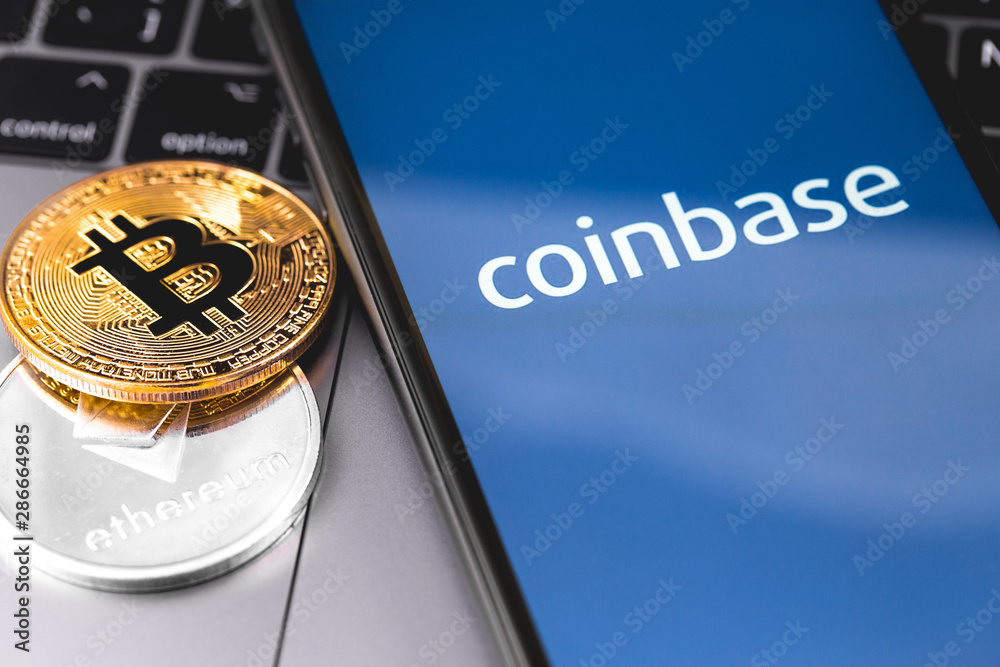 bitcoin, ethereum and smartphone with Coinbase logo on the screen. Coinbase is a digital currency exchange. Moscow, Russia - February 13, 2019