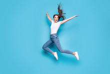 Full Body Photo Of Lovely Girl Raising Hands Arms Jumping Screaming Isolated Over Blue Background