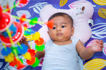 Wall Mural - The child is looking at colorful toys.