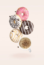 Creative Poster With Donuts. Doughnuts In Motion Falling On Pink Background. Sweet Donuts With White Cup Coffee Flying In Motion Or Falling.