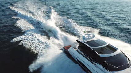 Wall Mural - Aerial view of a luxury yacht navigating fast.