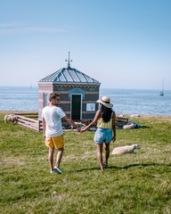 young couple on vacation at the old town of Hindeloopen Friesland Netherlands during summer