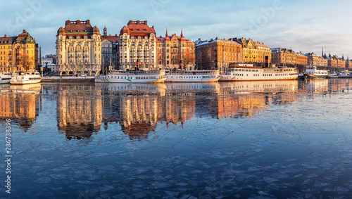 Stockholm waterfront with old architecture reflecting in the frozen bay in winter Wallpaper Mural
