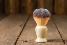 Soft Shaving Brush On Rustic Wooden Boards Background, Barber Shop Concept  