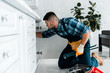 © LIGHTFIELD STUDIOS - selective focus of bearded man working in kitchen near toolbox with instruments