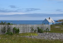 Wooden Picket Fence And Heritage Building Along The Western Shoreline Of Ile Aux Marin, Saint Pierre And Miquelon 