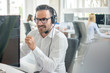 © Bojan - Confident customer support phone operator with headset working in call center