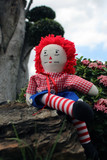 raggedy Anne doll sitting outside, Old Time Rag Doll, Ghost mystic doll. Scary horror doll