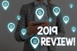 © Artur - Handwriting text writing 2019 Review. Conceptual photo remembering past year events main actions or good shows Woman wear formal work suit presenting presentation using smart device