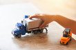 © Bigc Studio - child boy playing toys on table at home - kid hands playing toy car truck